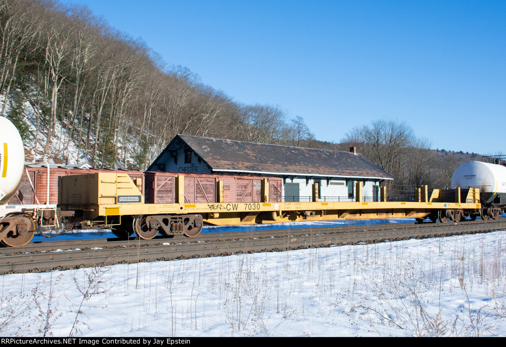 An empty stick-Rail car rides west on Q425